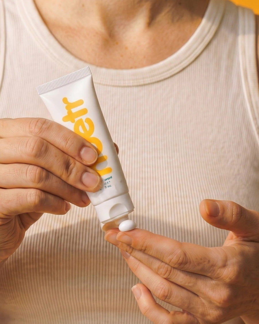 Pea-sized amount of noetr cream deodorant on a fingertip