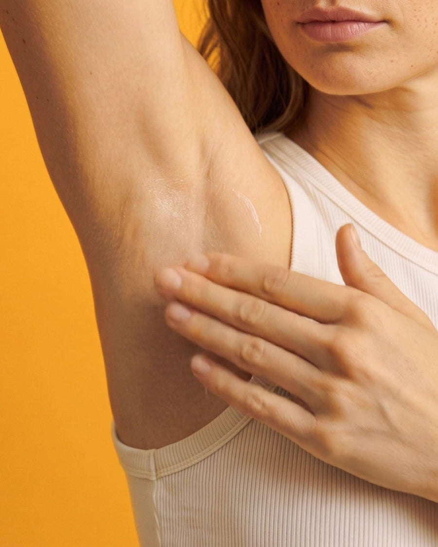 Applying noetr cream deodorant to the underarm